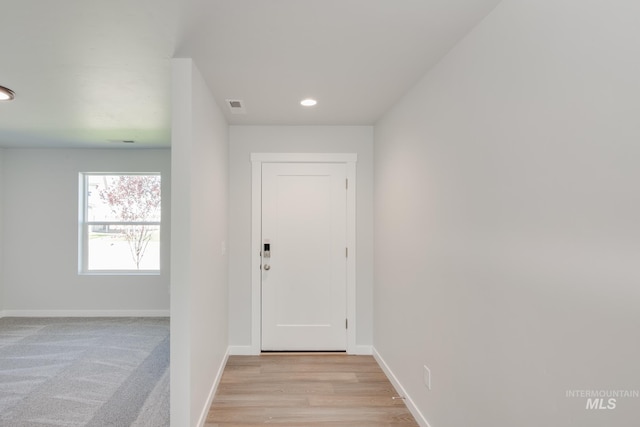 interior space featuring light wood-style floors, recessed lighting, visible vents, and baseboards