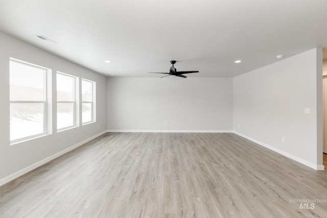 unfurnished room featuring light wood-type flooring, visible vents, baseboards, and recessed lighting