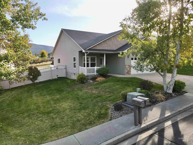 view of front of property featuring a mountain view, a front lawn, and covered porch