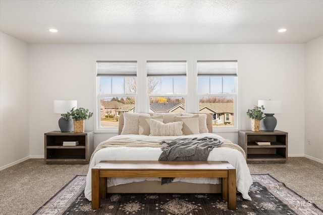 carpeted bedroom featuring recessed lighting, baseboards, multiple windows, and a textured ceiling