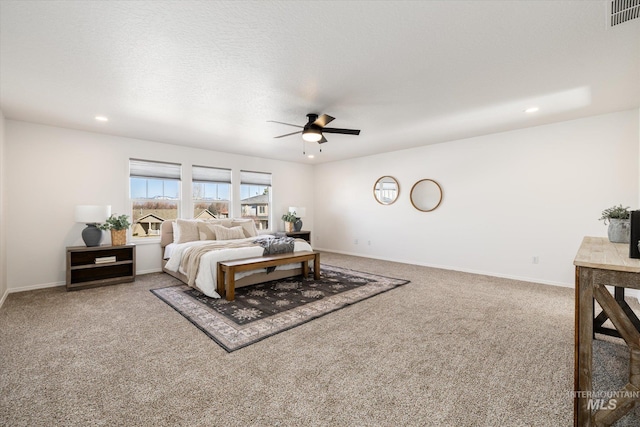 carpeted bedroom with baseboards, visible vents, recessed lighting, ceiling fan, and a textured ceiling