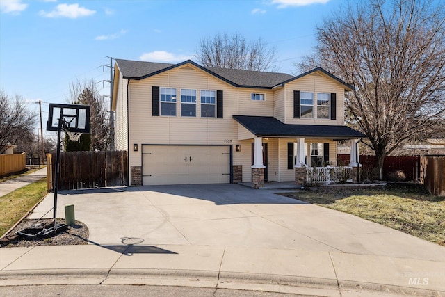 view of front of property featuring a porch, concrete driveway, fence, and an attached garage