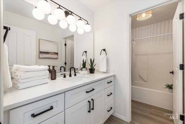 full bathroom with vanity, shower / tub combo, and wood finished floors