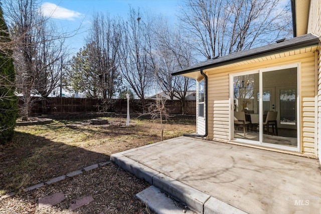 view of yard with a patio, fence, and a fire pit