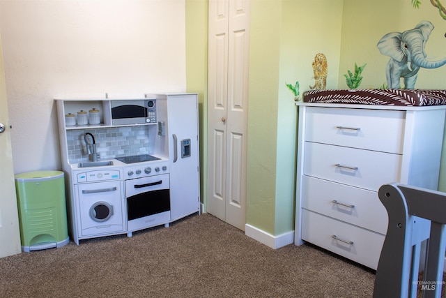 kitchen with a sink, backsplash, wall oven, carpet floors, and light countertops