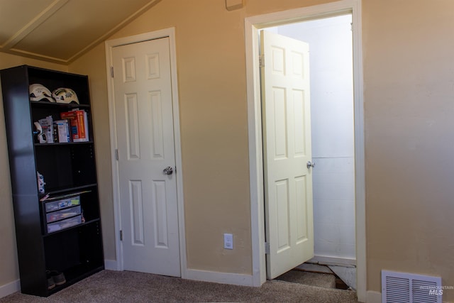 carpeted bedroom with visible vents, baseboards, and lofted ceiling