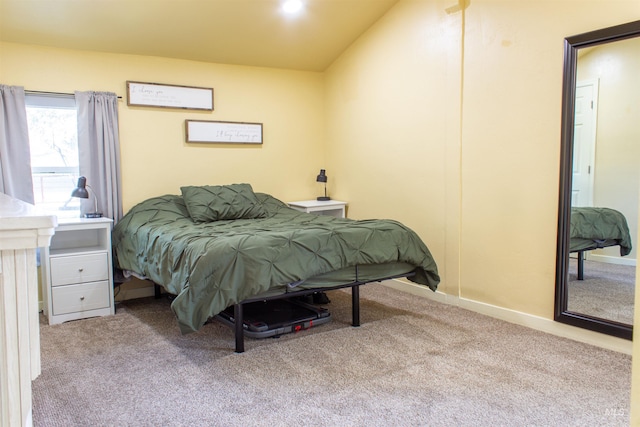 carpeted bedroom featuring baseboards