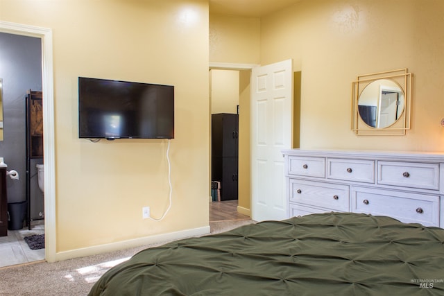 bedroom featuring light colored carpet and baseboards