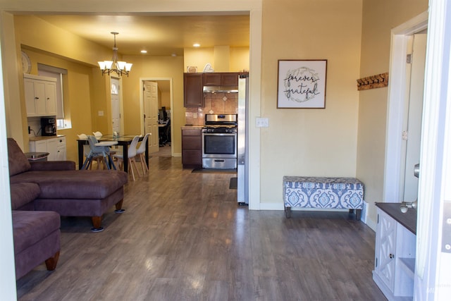 living area featuring dark wood finished floors, recessed lighting, baseboards, and a chandelier