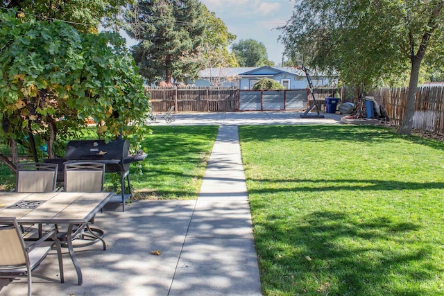 view of yard with outdoor dining space, a patio, and fence