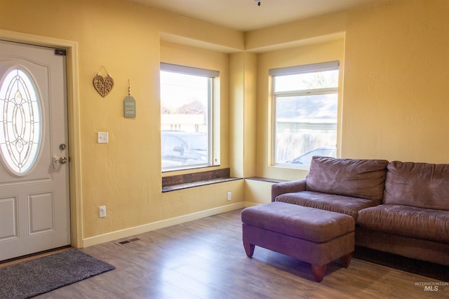 entryway with visible vents, baseboards, and wood finished floors