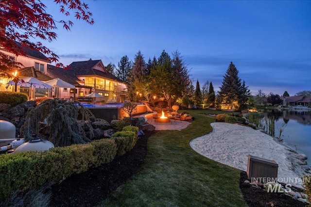 1122 W Two Rivers Ln, Eagle, ID 83616 - view of green lawn with a fire pit, a gazebo, a patio, and a water view