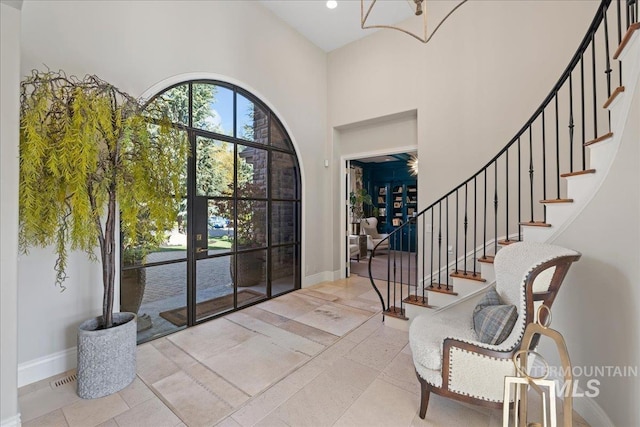 1122 W Two Rivers Ln, Eagle, ID 83616 - entryway featuring stairs, a high ceiling, baseboards, and a chandelier