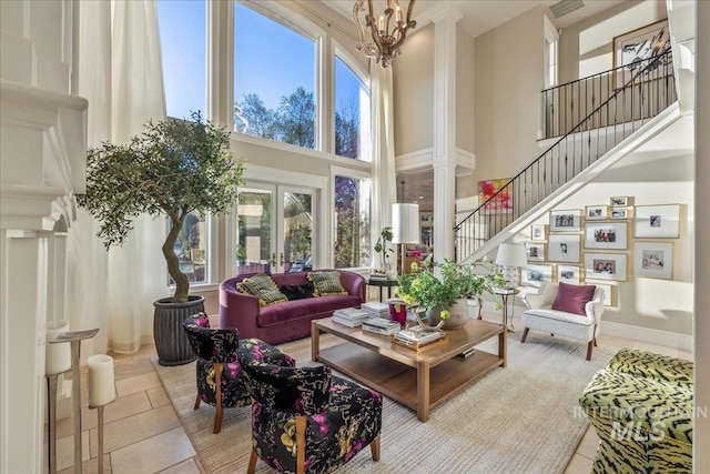 1122 W Two Rivers Ln, Eagle, ID 83616 - tiled living room with a high ceiling, decorative columns, healthy amount of natural light, and stairway