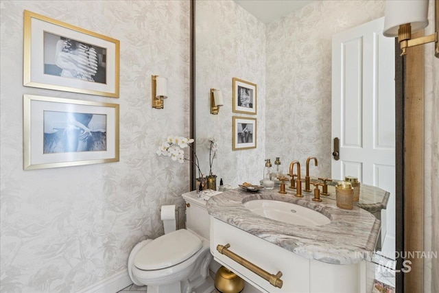 1122 W Two Rivers Ln, Eagle, ID 83616 - bathroom featuring wallpapered walls, vanity, toilet, and baseboards
