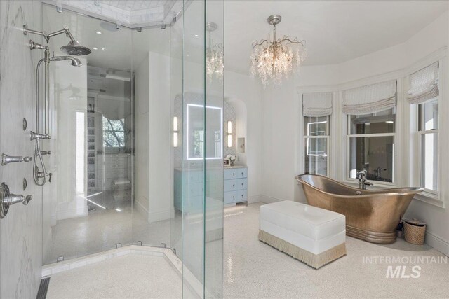 1122 W Two Rivers Ln, Eagle, ID 83616 - bathroom with a stall shower, healthy amount of natural light, a freestanding tub, and a chandelier