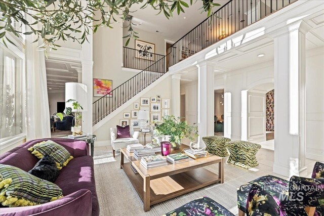 1122 W Two Rivers Ln, Eagle, ID 83616 - living room with decorative columns, a towering ceiling, stairway, a decorative wall, and tile patterned flooring