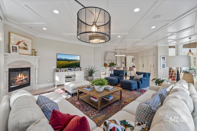 1122 W Two Rivers Ln, Eagle, ID 83616 - living area featuring coffered ceiling, recessed lighting, a glass covered fireplace, baseboards, and decorative columns