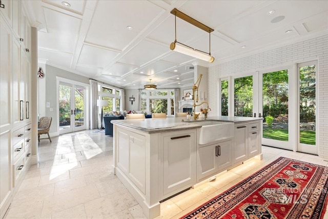 1122 W Two Rivers Ln, Eagle, ID 83616 - kitchen featuring french doors, coffered ceiling, a sink, white cabinetry, and an island with sink