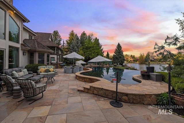 1122 W Two Rivers Ln, Eagle, ID 83616 - pool at dusk with a patio area, outdoor lounge area, and an outdoor pool
