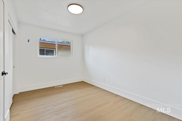 unfurnished room featuring light wood-style floors and baseboards