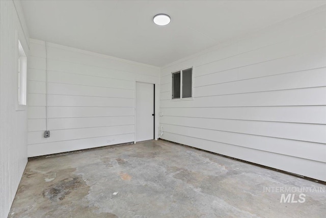 unfurnished room featuring unfinished concrete floors