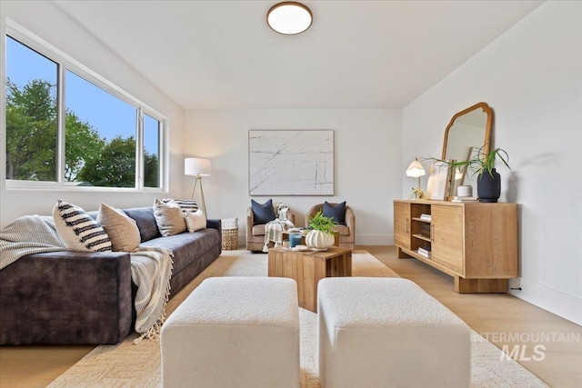 living area with light wood-style floors and baseboards