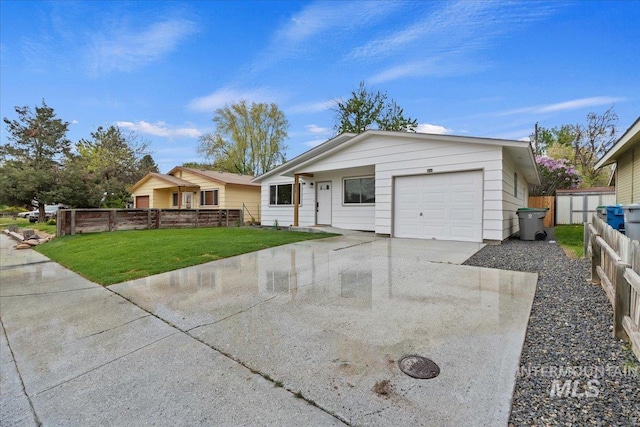 ranch-style house featuring fence, an attached garage, driveway, and a front yard