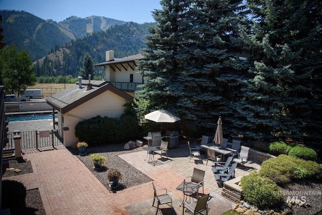 351 S 2nd Ave Unit 602, Ketchum, ID 83340 - view of patio / terrace with a mountain view, a gate, and grilling area