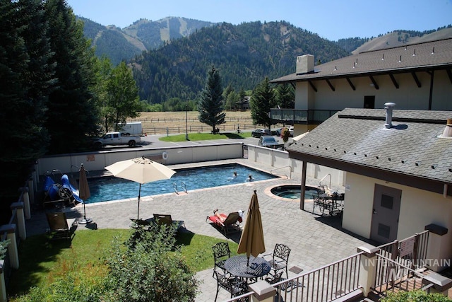 351 S 2nd Ave Unit 602, Ketchum, ID 83340 - view of swimming pool with a mountain view, a patio area, and outdoor dining area