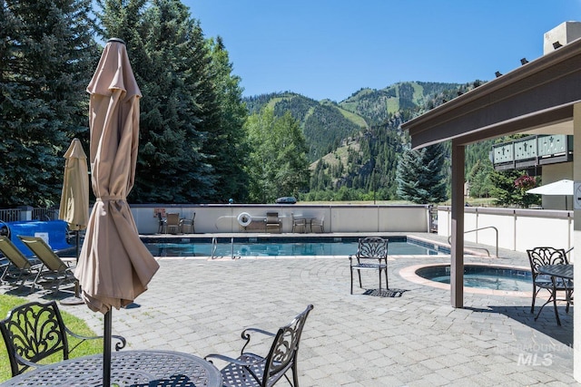 351 S 2nd Ave Unit 602, Ketchum, ID 83340 - community pool with a mountain view, a hot tub, and a patio area
