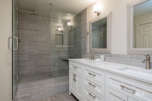 351 S 2nd Ave Unit 602, Ketchum, ID 83340 - bathroom with a stall shower, double vanity, and wood finished floors