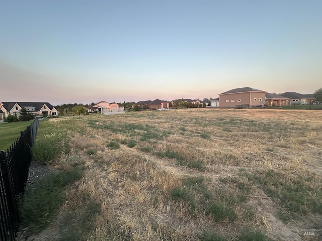 view of yard featuring a residential view and fence