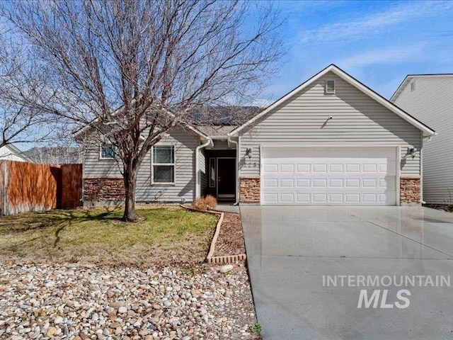 single story home featuring a garage, stone siding, driveway, and fence