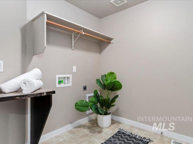 clothes washing area with baseboards, visible vents, hookup for an electric dryer, laundry area, and washer hookup