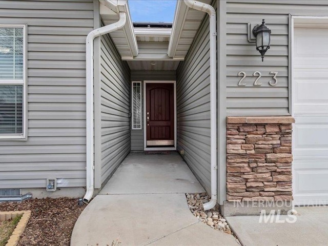 doorway to property featuring a garage