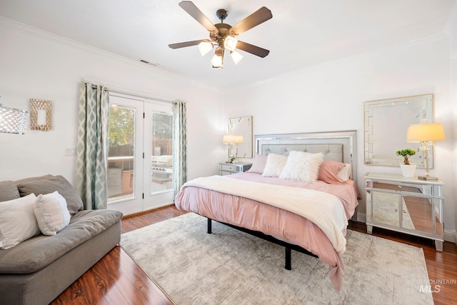 bedroom with a ceiling fan, wood finished floors, access to outside, ornamental molding, and visible vents