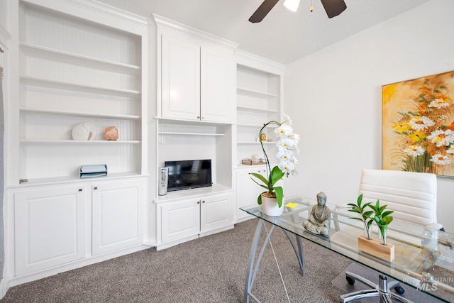 home office with carpet floors, built in shelves, and ceiling fan