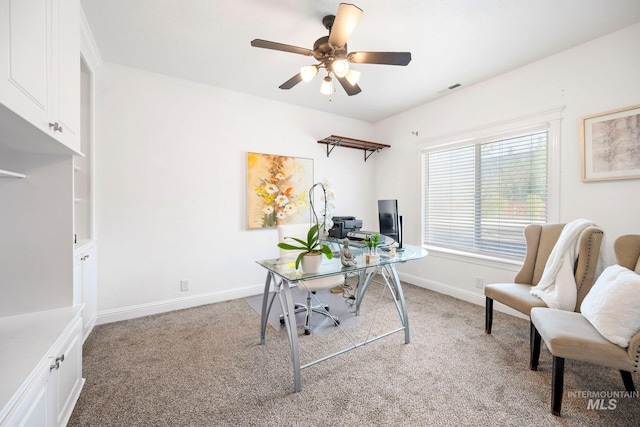 office with visible vents, light carpet, a ceiling fan, and baseboards