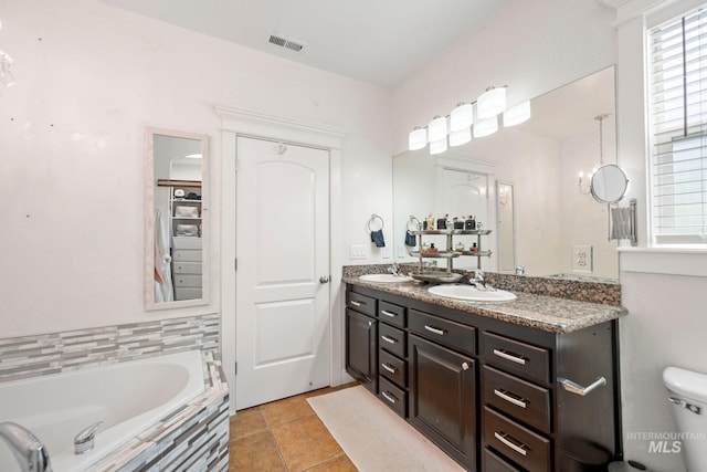 bathroom with a healthy amount of sunlight, a sink, and visible vents