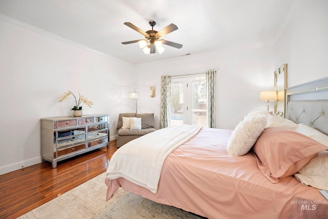 bedroom with wood finished floors, access to exterior, visible vents, crown molding, and baseboards