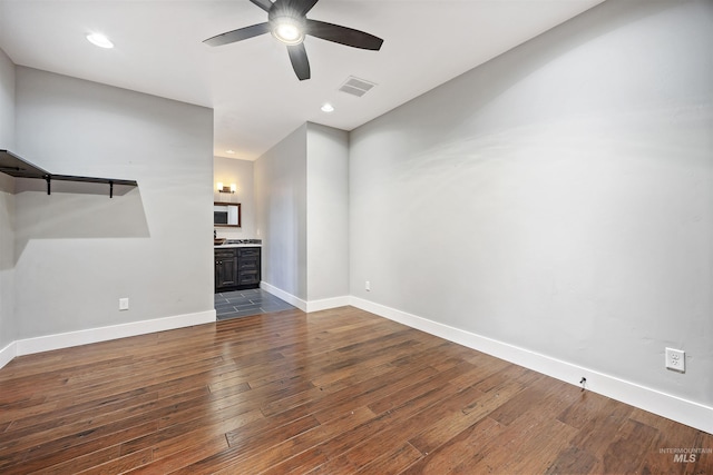 unfurnished living room with dark wood-style floors, visible vents, baseboards, recessed lighting, and ceiling fan