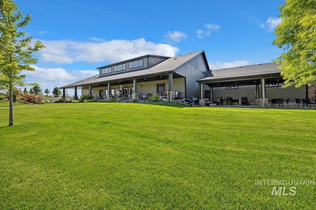 back of house featuring a patio and a yard