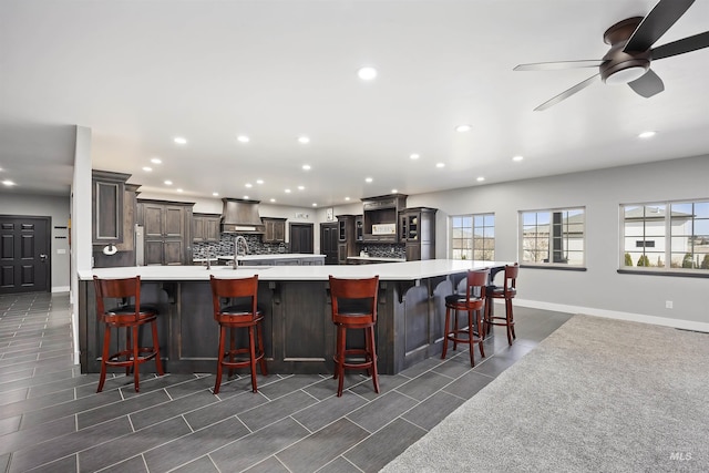 kitchen with recessed lighting, decorative backsplash, and light countertops