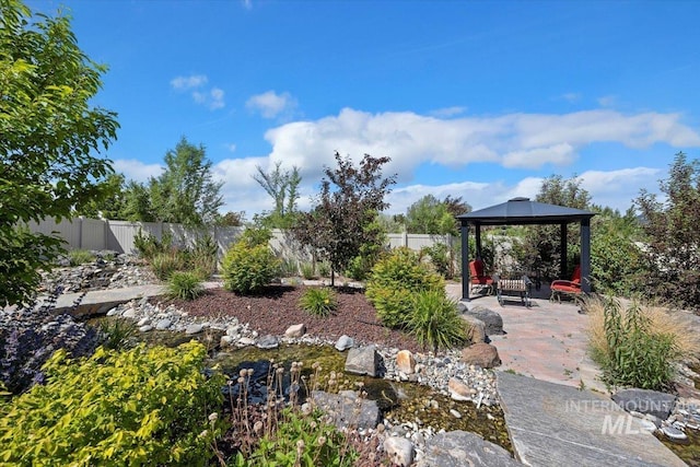 view of yard with a gazebo, a patio area, and a fenced backyard