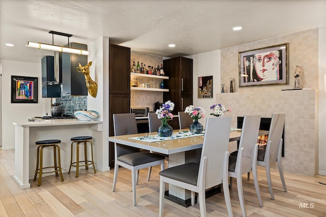 2402 Columbus, Boise, ID 83705 - dining room featuring light wood-style floors, recessed lighting, baseboards, and a bar