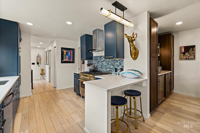 2402 Columbus, Boise, ID 83705 - kitchen with stainless steel stove, light wood finished floors, light countertops, backsplash, and recessed lighting