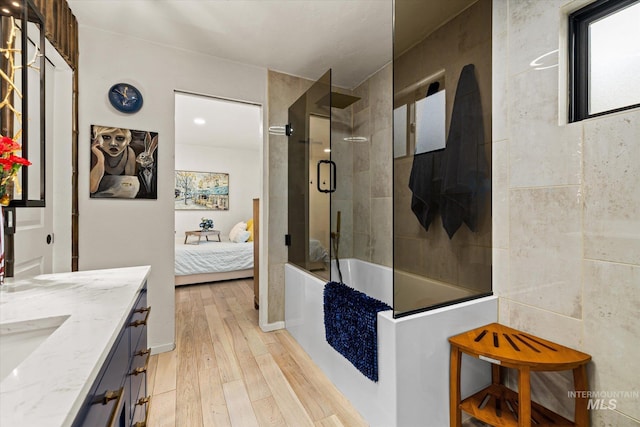 2402 Columbus, Boise, ID 83705 - ensuite bathroom featuring wood-type flooring, vanity, and enclosed tub / shower combo