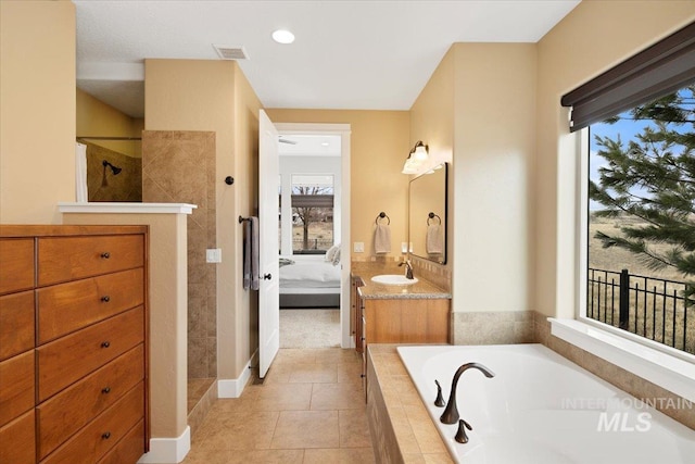 ensuite bathroom with visible vents, connected bathroom, tile patterned flooring, walk in shower, and a bath