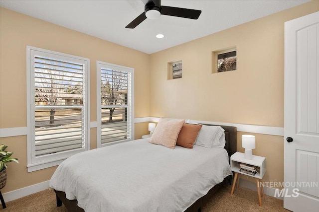 carpeted bedroom featuring ceiling fan and baseboards